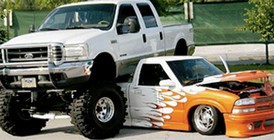 Suspension Lifted Truck Parked over a Suspension Lowered Truck